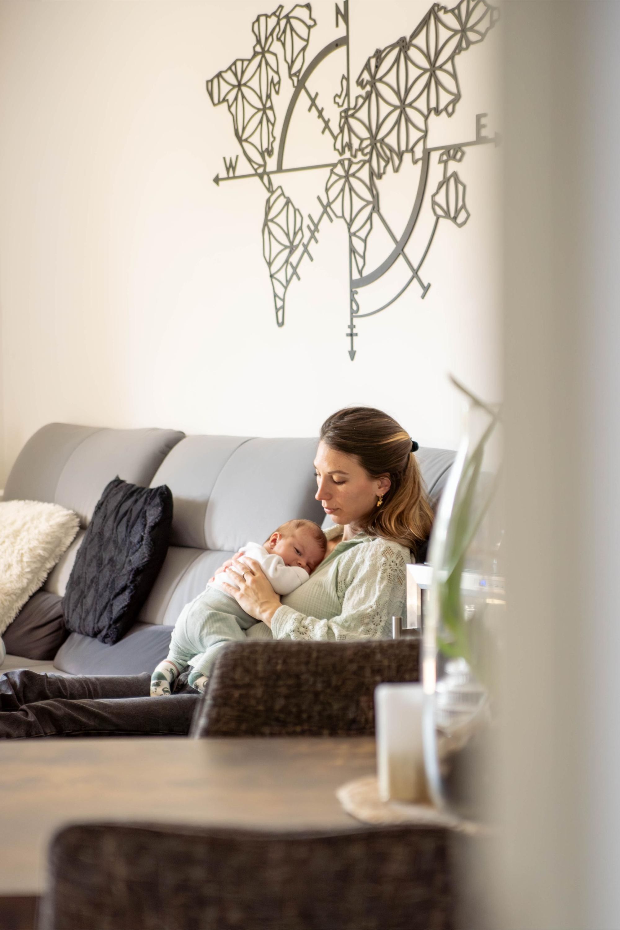 photo d'une maman portant son bébé lors d'une séance photo à domicile à Besançon