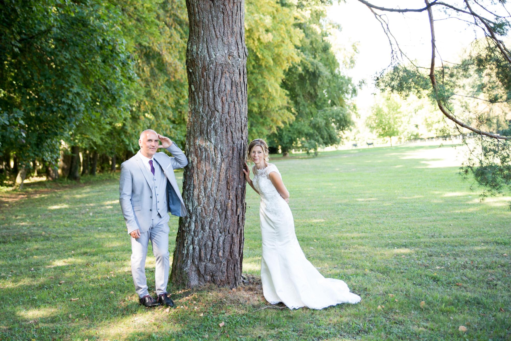 photo de mariés pendant la séance photo de couple à Vesoul, mariés autour d'un arbre, regardent dans la même direction